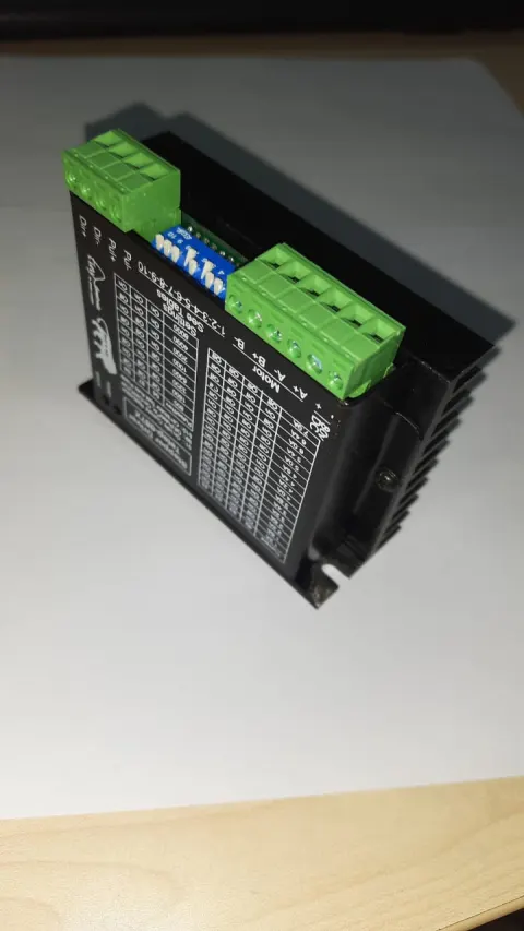Tstep-117X two-phase stepper drive, angled view showing the DIP switch bank and motor terminals